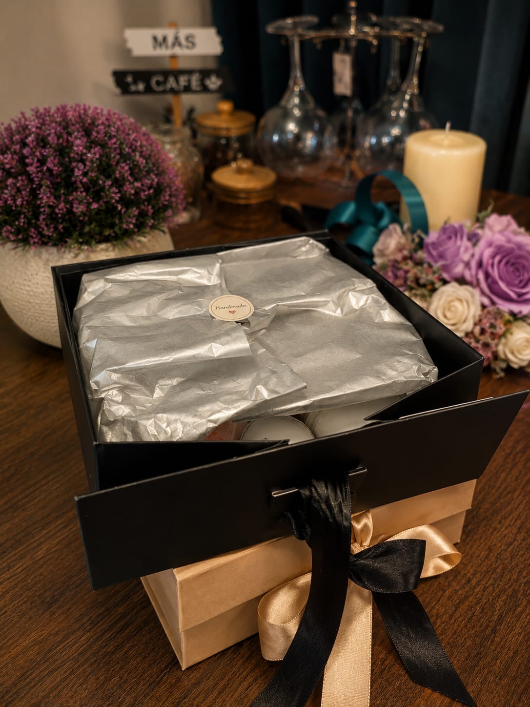 An open gift box lined with tissue and a Handmade seal, ready to be filled