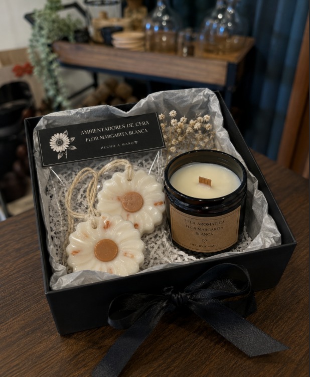 Black gift box with an amber wood-wick candle and hanging daisy wax fresheners