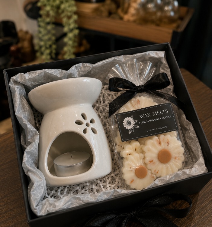 Black gift box with a white ceramic wax burner and a bag of white daisy wax melts